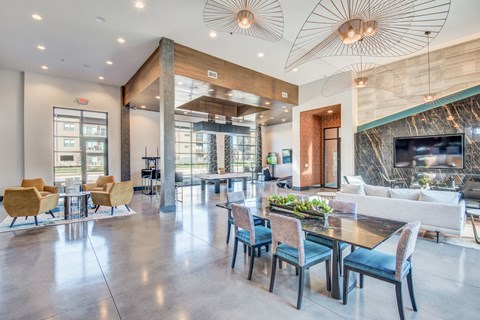 a living room and dining room with a table and chairs